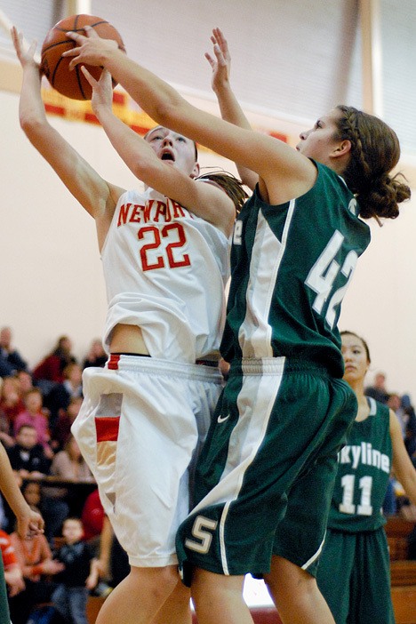 Knights guard Betsy Kingma (22) is fouled by Spartan post Amy Ziegler (42) during a game at Newport High School in Bellevue on Friday.