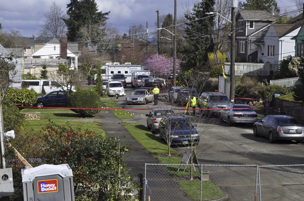 A car sits in the middle the street in Seattle’s Columbia City neighborhood where robbery suspect Russell Smith was shot and killed by members of the Bellevue Police Department SWAT team as they attempted to serve a warrant.