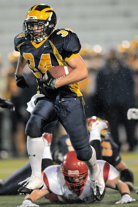 Wolverine RB Joey Mangialardi (34) breaks through the Mount Si defense for a long touchdown run in the first half of a 3A playoff game at Bellevue on Friday. Bellevue won 49-17.