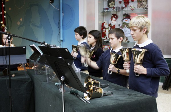 Seventh graders from Holy Family Parish School perform the handbells at Crossroads on Tuesday
