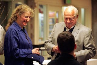 Baseball hall of famer Tommy Lasorda prepares to sign a hat for Sandra Jacobson