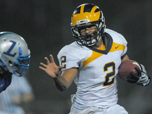 Wolverine QB Kendrick VanAckeren (2) runs for a gain at Liberty on Friday. Bellevue won by a field goal late in the fourth quarter