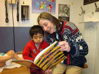 Dr. Nancy Danoff reads to a patient during a checkup at the Eastgate Public Health clinic in Bellevue.