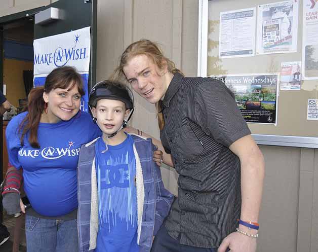 (Left to right) An official from Make A Wish stands with Ethan Zakes and Sky Siljeg during an event at Bellevue Skate Park before Ethan passed in 2011.