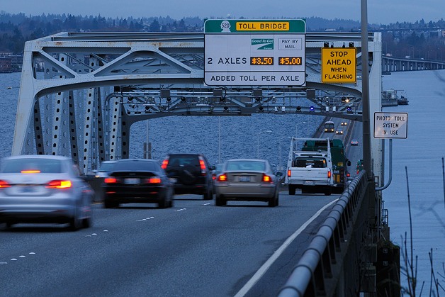 Traffic flows Westbound across the State Route 520 floating bridge on the first day of active tolling in this view from Medina on Thursday morning