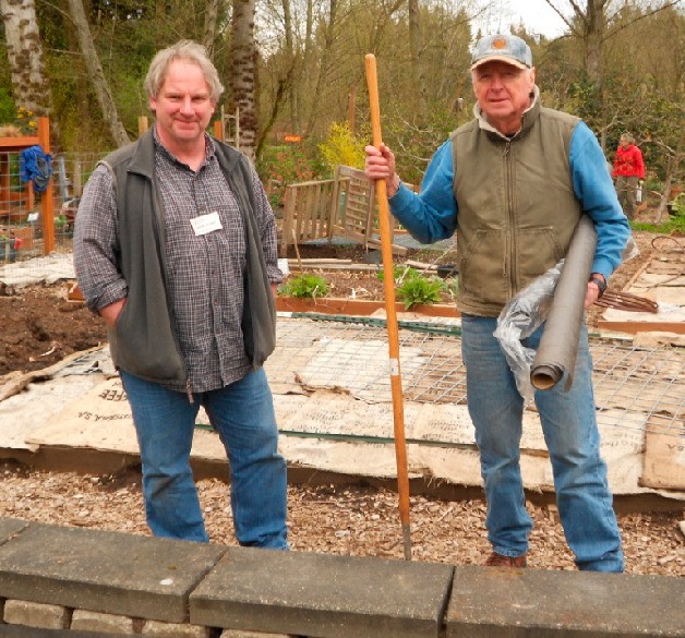 Master Gardeners Mark Sevonty and Wally Prestbo prepare for the installation of a new cactus garden.