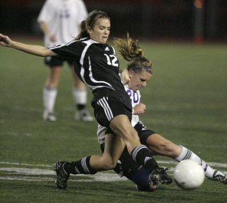 Sammamish's Emily Moore (in black) collides with Sumner's Kelsey Hansen during the 1st round of the 3A Girls Soccer Playoffs at Sumner on Wednesday
