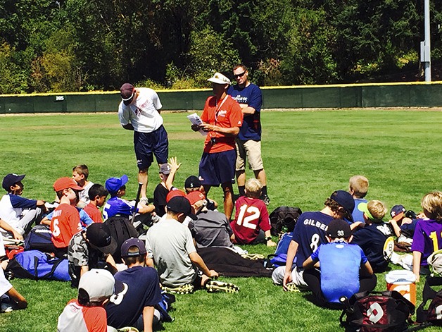Bellevue Bulldogs baseball head coach Mark Yoshino shares words of encouragement with players at camp.