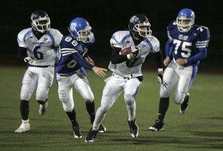 Interlake's WR/DB Christian Larzalere runs with the ball as North Mason's WB/CB Tim Winslow tries to catch up