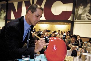 Mariners Manager Don Wakamatsu paints the left eye of the Japanese Daruma doll