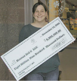 Beth Schrader of Bellevue holds a lottery check indicating her family