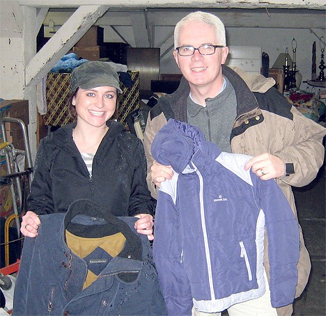 Jamie Wood (Cooley Smiles – Dental Hygienist) and Richard Bray (St. Vincent de Paul Society of Seattle/King County) hold some of the coats collected by Cooley Smiles Dentistry of Bellevue. Cooley Smiles in Factoria collected 125 coats in a recent coat drive and delivered them to St. Vincent de Paul