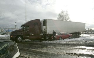 A semi truck is stuck on the I-405 ramp onto Northeast Eighth Street on Monday