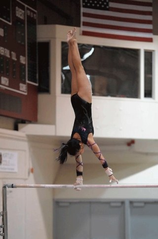 Dana Bonincontri performs on the bars at the State Gymnastic Meet held at Seattle Pacific University. Bonincontri