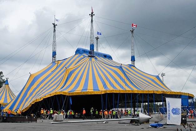 Workers raise the big top for the upcoming Cirque Du Soleil production of KOOZA at Marymoor Park in Redmond on Thursday
