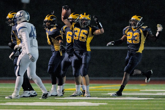 Wolverines LB William Bissell (36) celebrates a first half interception against Liberty on Friday. Bellevue beat the Patriots 35-0.