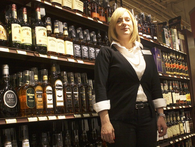 Bellevue Way Safeway Manager Rochele Anderson in the store's liquor aisle the night before sales began. The store began selling spirits in Washington at 6 a.m. Friday.