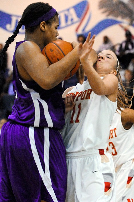 Newport wing Maddison Small (11) takes an elbow to the face from Garfield center Cora McManus on a rebound during the 4A KingCo girls title game at Juanita High School in Kirkland on Friday.