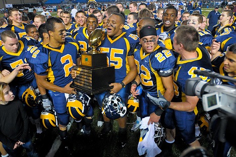 The Bellevue Wolverines celebrate their 3A football state championship at the Tacoma Dome on Friday.