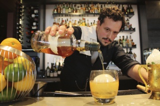 Andrew Bohrer prepares a “whiskey on the rock” at Chantanee Thai Restaurant’s new location behind the Key Center on 108th Avenue Northeast in Downtown Bellevue.  Bohrer says the ice ball helps chill the bourbon evenly without distilling it.