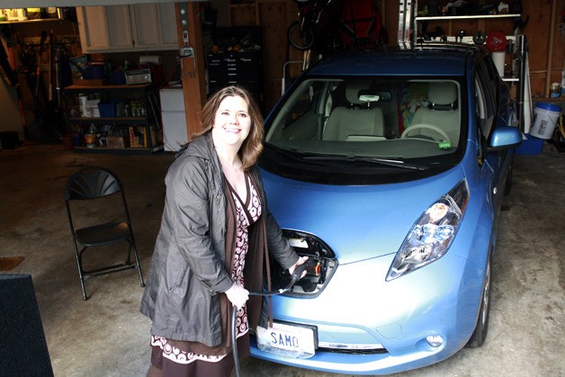 Bellevue resident Samantha Quick plugs her Nissan Leaf into her home charger. Quick is the first recipient under the EV Project in Washington
