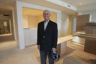 Ken Schoenfeld stands in what will become his and his wife's condo unit at Bellevue Towers.