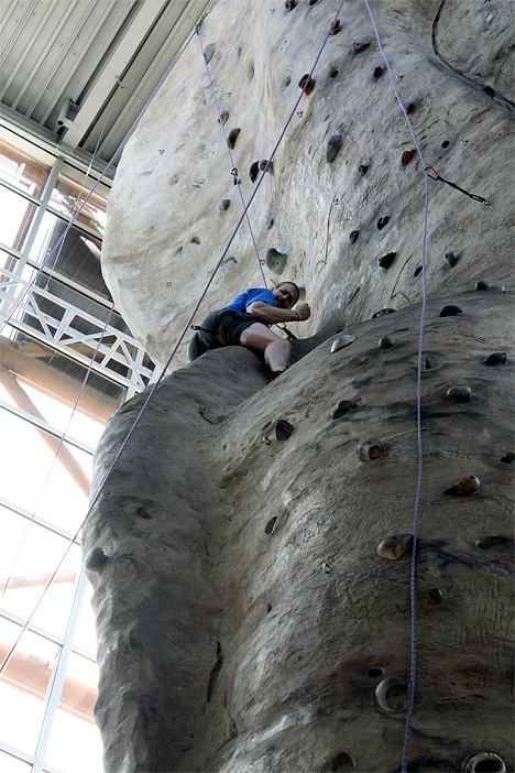 Paul Miller tries his hand at the climbing wall at the REI store in Seattle. He and others completed a climb of Mt. Rainier to raise funds and awareness for Duchenne Muscular Dystrophy