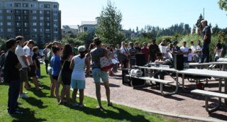 Bellevue High School senior Taylor Moe tries to rally the morale of students at a rally at Bellevue's Downtown Park on Tuesday