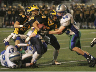 Bellevue’s Peter Nguyen plows through the Liberty line before being stopped by Turner Chatterton on Friday