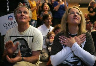 Scott and Karen McKinley react to the broadcast of Barack Obama speaking in Chicago on the election night at the  Westin Hotel in Seattle on Tuesday