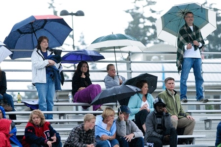 Spectators don't let a little rain ruin their day