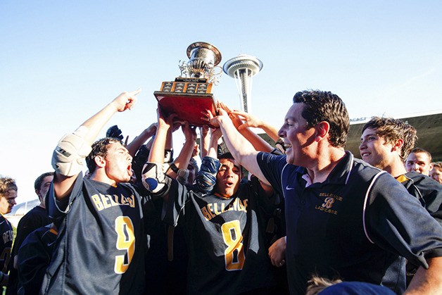 Bellevue players celebrate their Division I lacrosse state title with head coach John Baumann at Seattle Memorial Stadium after beating Issaquah 8-0.