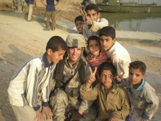 Army Spec. Tim Thorpe was named Soldier of the Month for his battalion. Here he poses with Iraqi children at a bridge-building site.