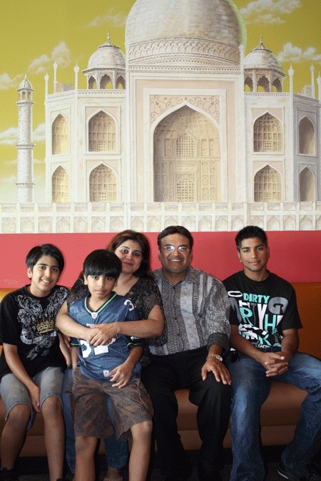 Moghul Palace reopened in Bellevue last week after an 11 month hiatus. Owner Alam Malik (middle) sits with his wife