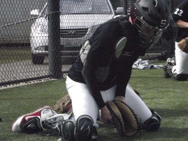 Sammamish catcher Craig Sweet practices a blocking drill during practice.