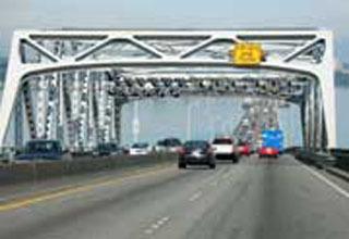 This mock-up photo shows what tolling would look like on Highway 520 with sensors on the bridge gantries.