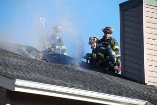 Fire crews battle a fire in a condo attic on Monday