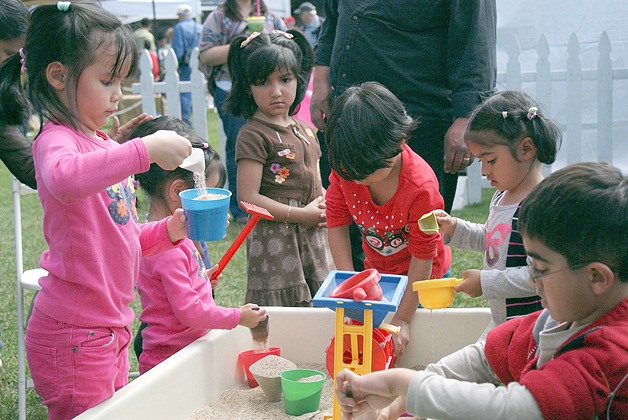 Children at the Strawberry Festival on June 23 find activities to do at the Eastside Pathways booth.