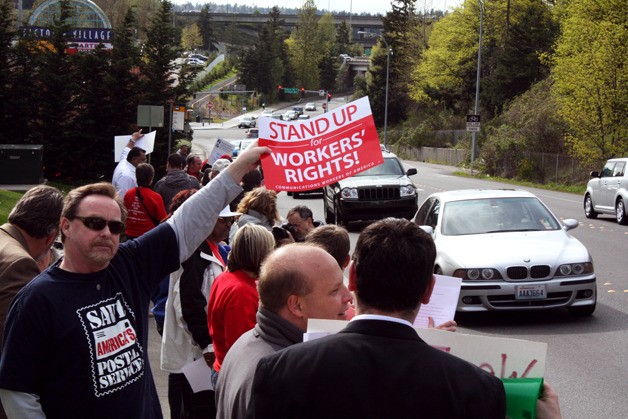 Protesters line Southeast 36th Street in Bellevue to protest T-Mobile's decision to close seven call centers.