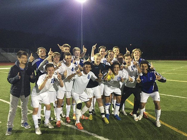 The Bellevue Christian Vikings boys soccer team celebrates after defeating the Klahowya Eagles 1-0 in the Class 1A West Central District III championship game on May 14 in Orting.