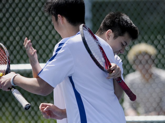Sammamish's Benny Tran and Andrew Nguyen celebrate together after a win during the Sea-King District doubles tournament on Wednesday. Tran and Nguyen made the finals before falling to the duo from Seattle Prep