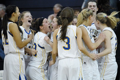 The Bellevue Wolverine girls basketball team celebrates 59-57 win over Mercer Island on Wednesday.