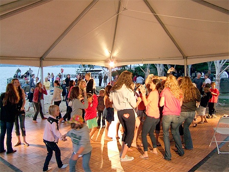 People dance under a tent at Medina Days