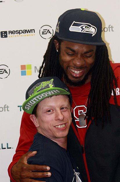 Seattle Seahawks cornerback Richard Sherman poses with a fan during Monday's release party for Titanfall