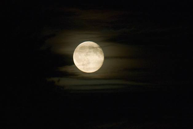 An autumn moon rises through a thin cloud layer over Bellevue on Friday. The National Weather Service calls for mostly sunny and a high near 73 degrees for Saturday in Bellevue.