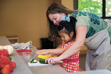 Teacher Julie Barker works with 6-year-old student