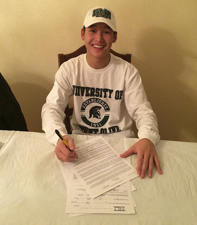 Newport Knights senior Justin Lau signs a letter of intent with the University of Mount Olive Trojans lacrosse team.