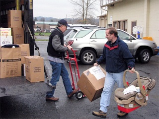 Dick Scott and Kevin Brown load an order for a food bank.