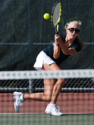 Wolverine Alaina Goesling returns a volley during singles match play against Mercer Island at Bellevue on Thursday