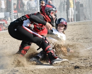 Bellevue's Katie Savard is tagged out at home plate by Totems catcher Tania Quijada on Wednesday. Bellevue won 3-0.